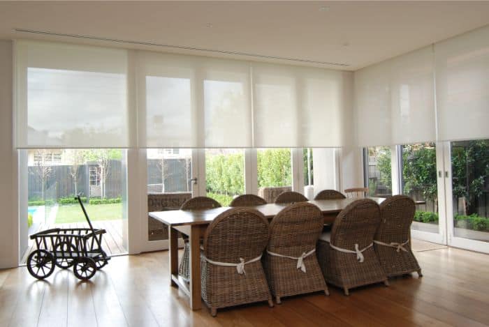 Motorised Blinds & Roller Blinds Melbourne - a room with a large dining room tables, eight large chairs and big windows