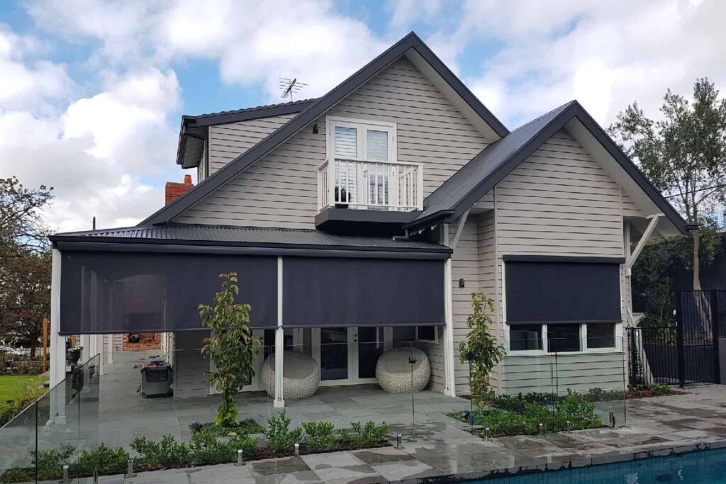 External Blinds & Outdoor Blinds Melbourne - view from outside a house with blinds half lowered coving the windows and porch