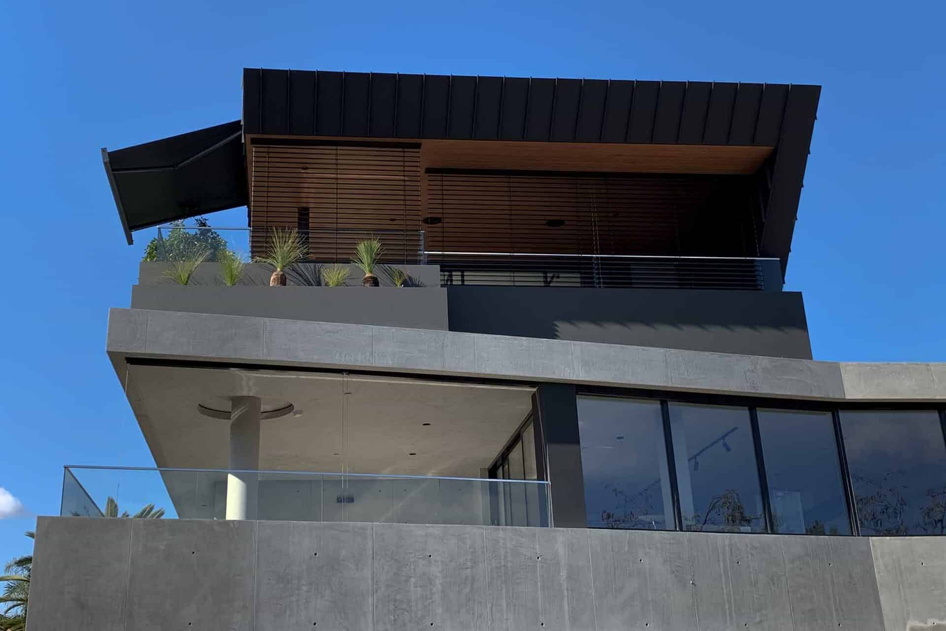 Folding Arm Awnings & Markilux Awnings Stockist - a view looking up at double story house