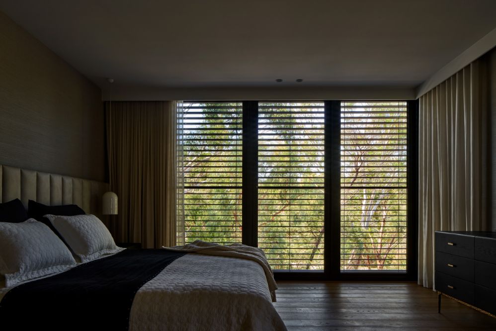 External Venetian Blinds - a bedroom protected by external Venetian blinds and sheer indoor curtains