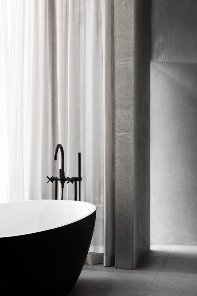 Roman Blinds & Curtains Melbourne - A bathroom protected by a white curtain in the background for privacy.