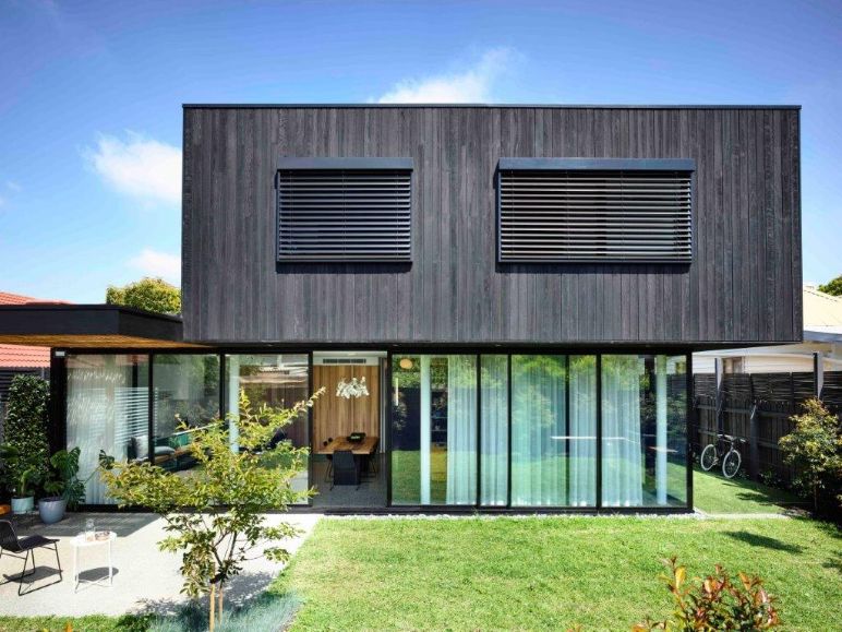 External Venetian Blinds - external Venetians on glass and wooden home, with indoor sheer white curtains