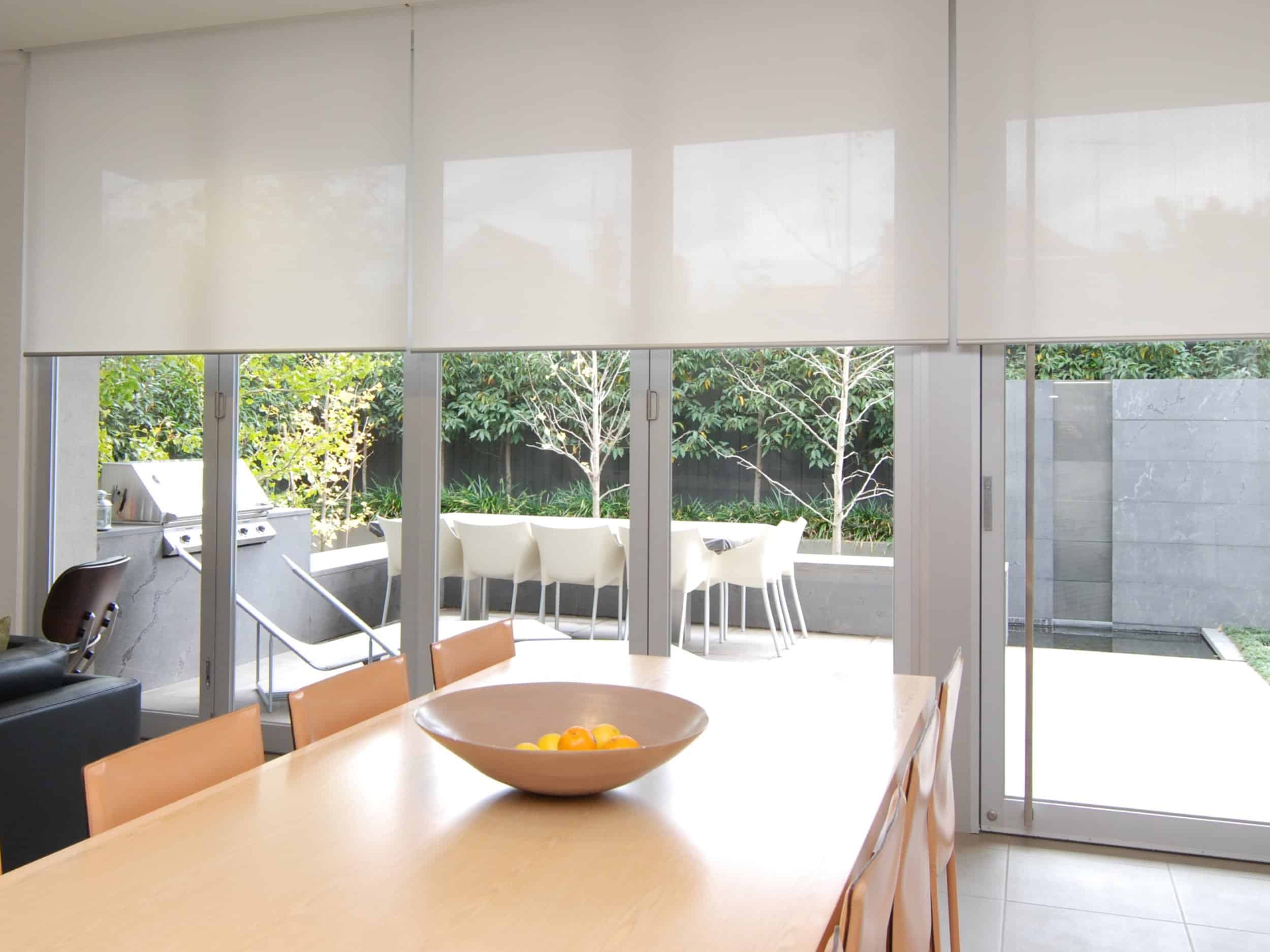 Benefits of window dressing - A dining room protected from the harsh outdoors with window dressings