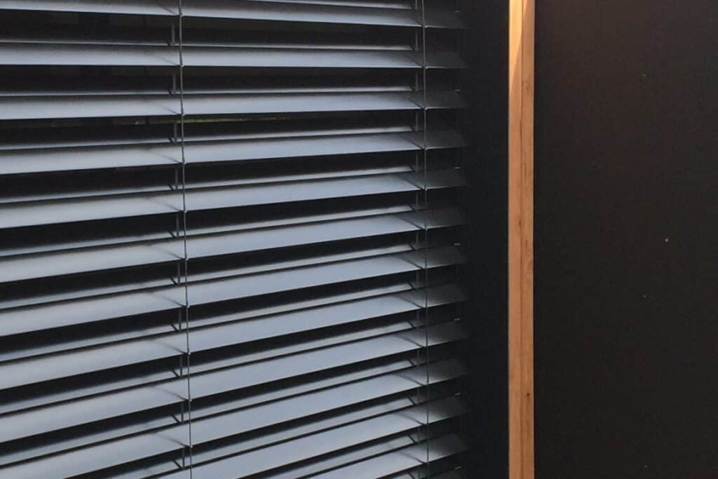 A close up of automated external Venetians blinds in black