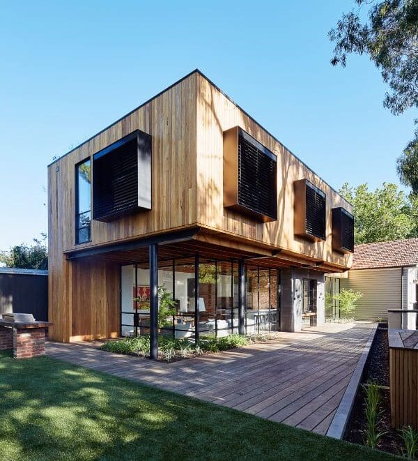 A wooden exterior on a home with recessed pelmets and roller blinds