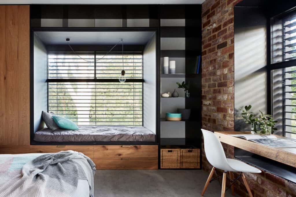 A room with a window nook with blinds helping to keep the home energy efficient