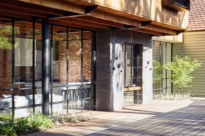 An outdoor area with windows without window furnishings facing onto the street