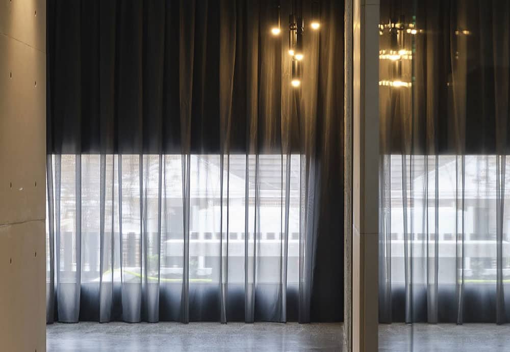 A combination of motorised blinds and sheer curtains