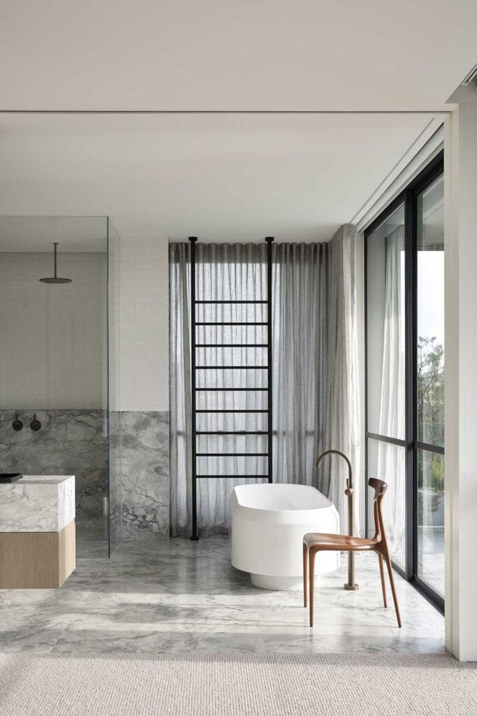 A bathroom area in the home with windows and sheer curtains