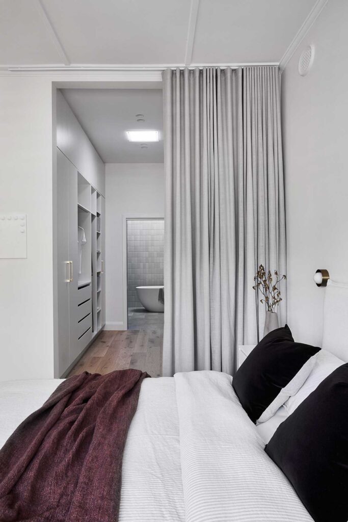 Sheer curtain used a screen between walk in robe and bedroom