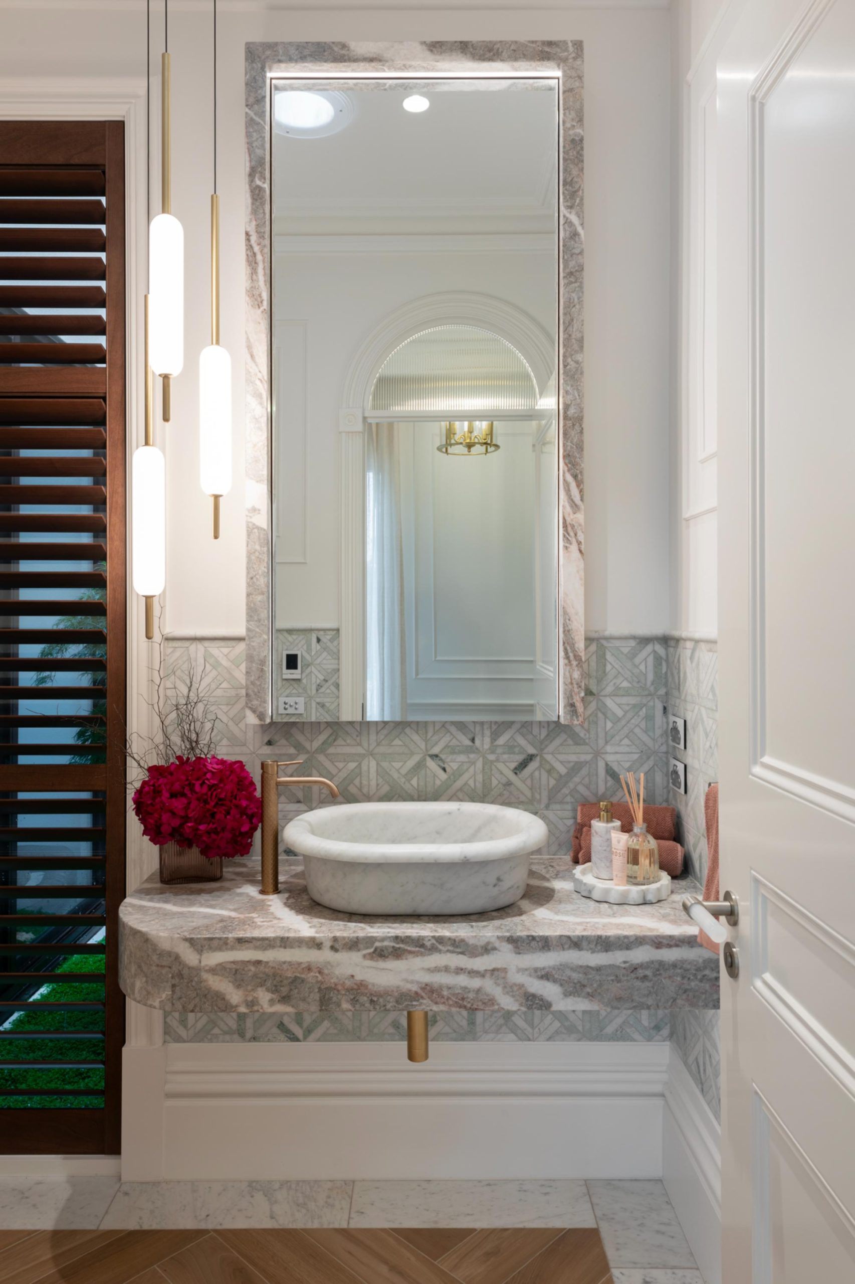 Luxury Marble tessalated tiles in powder room with dark timber Norman Plantation Shutters