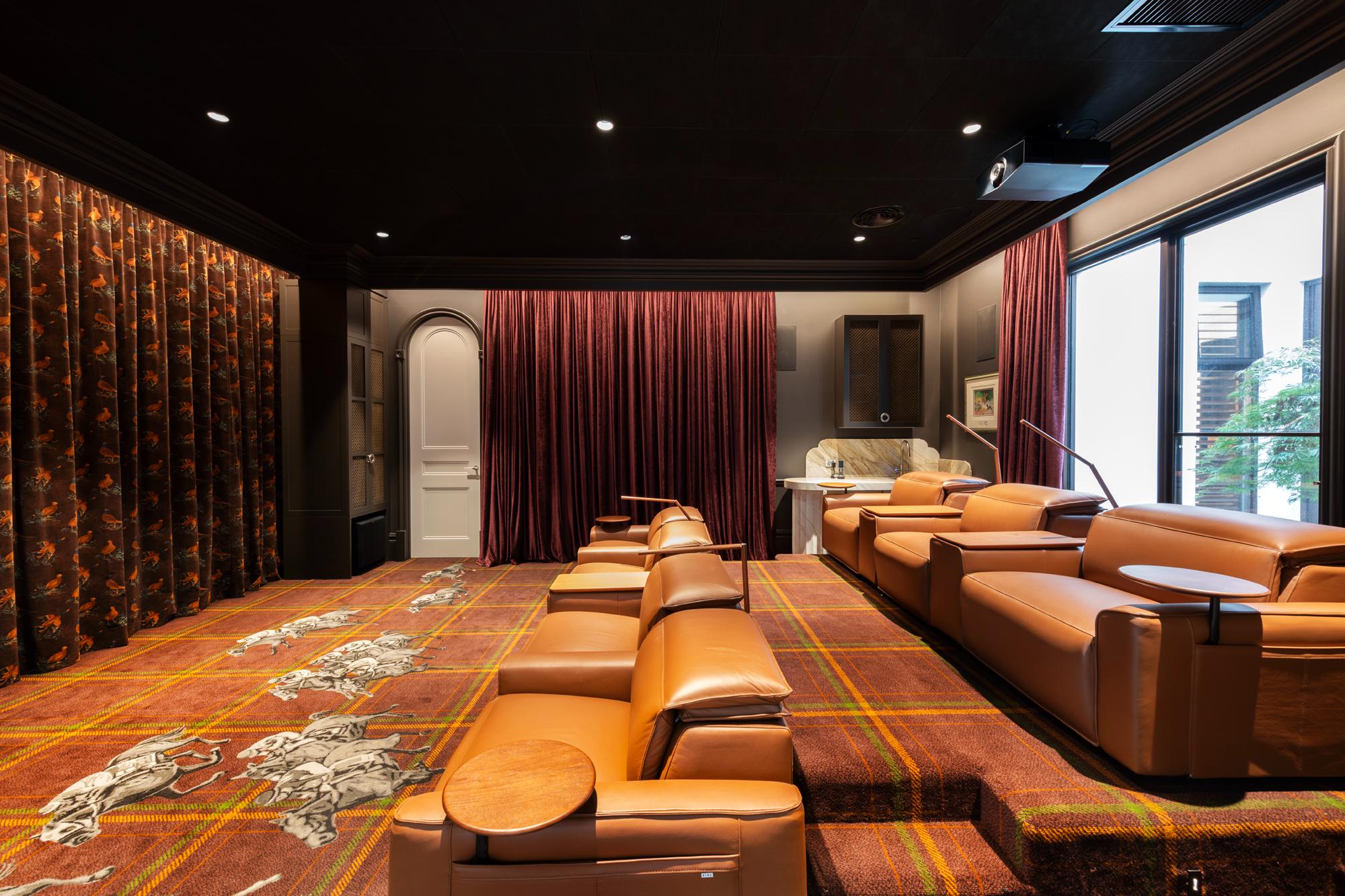 Luxury home theatre with custom made curtains with velvet curtains featuring racehorses designed specifically for this room.