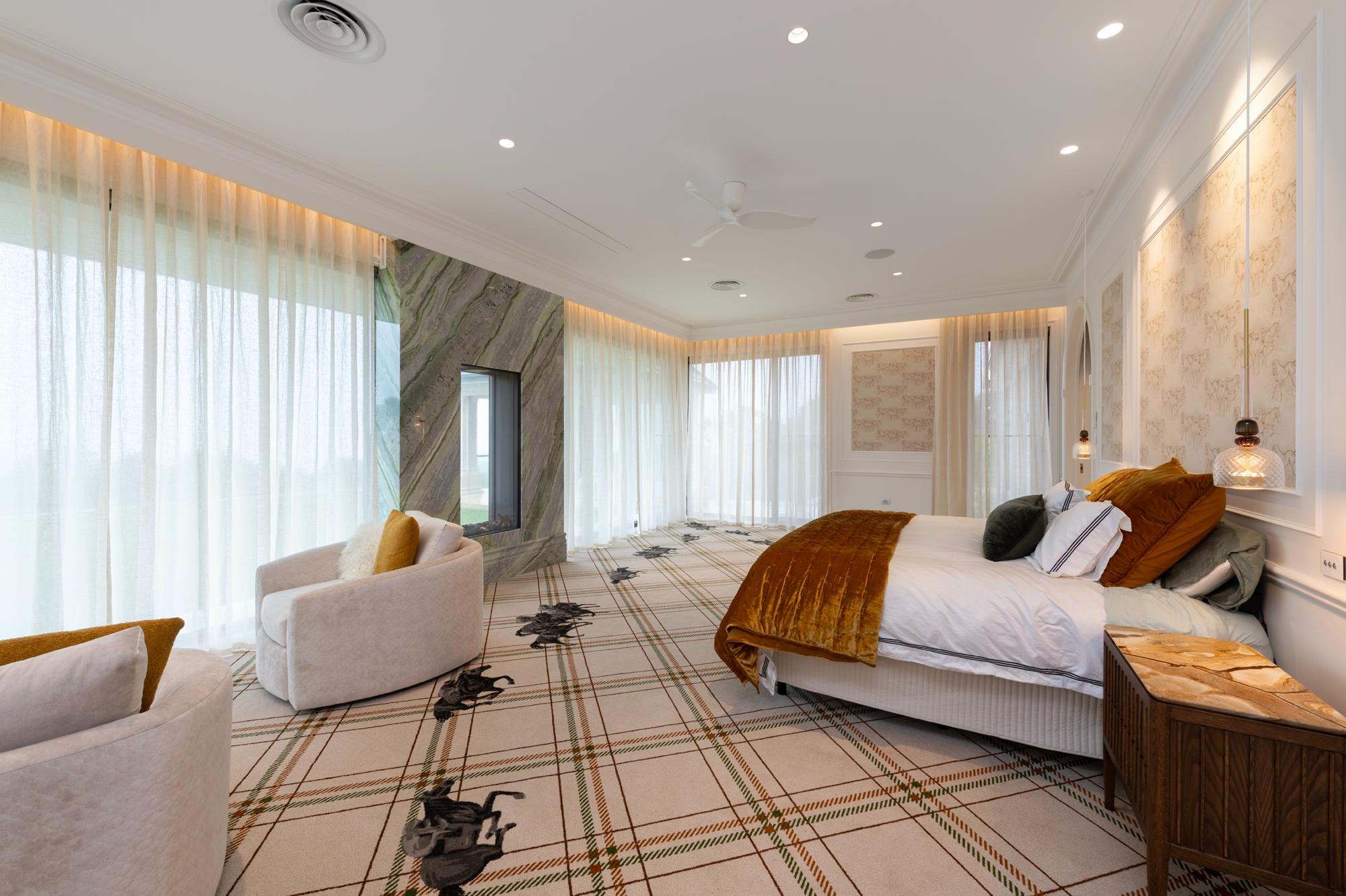 Large bedroom expansive windows with motorised sheer curtains closed, lighting in pelmets, customised carpet and wallpaper featuring racehorses