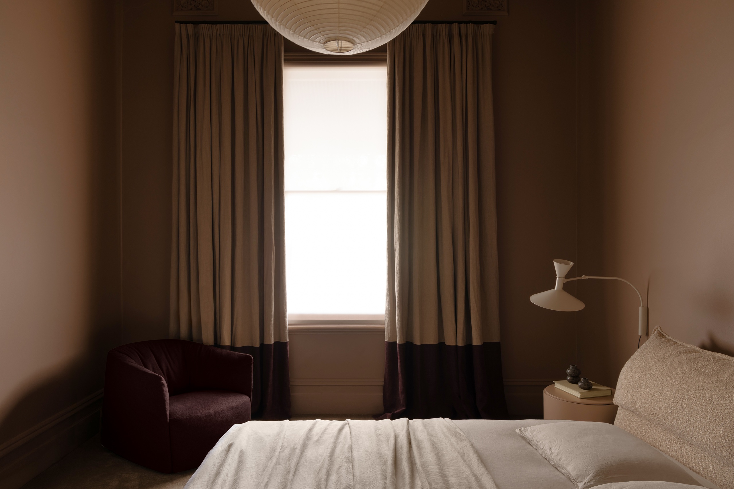 WD Residence Toorak - master bedroom with custom window furnishings, banded blockout curtains open and sunscreen blind behind filtering light into room