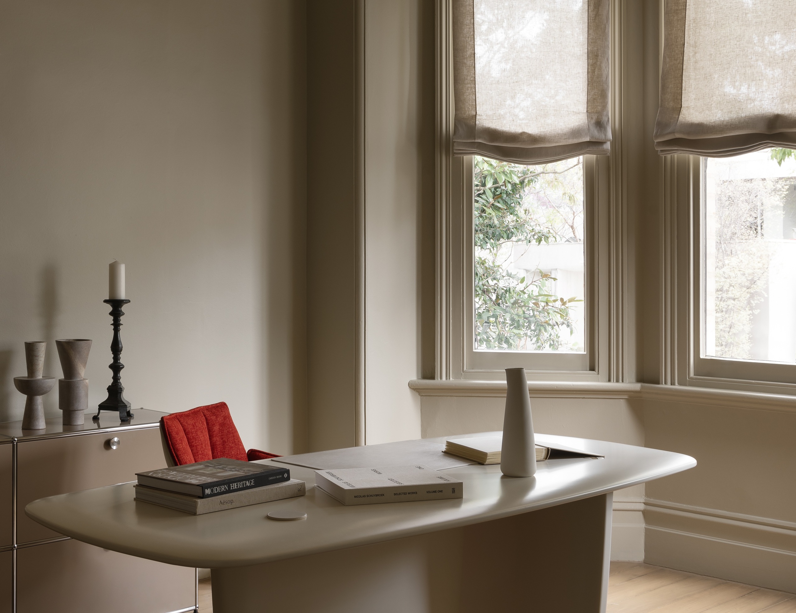Soft unlined linen motorised roman blinds in period bay window of WD Residence Toorak showing filtered light onto study desk